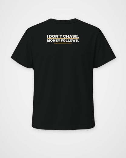 Black regular fit tee, back view, print reading I don't chase. Money follows – digital mockup