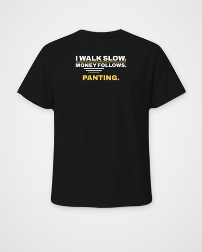 Black regular fit tee, back view, print reading I walk slow. Money follows. Panting – digital mockup
