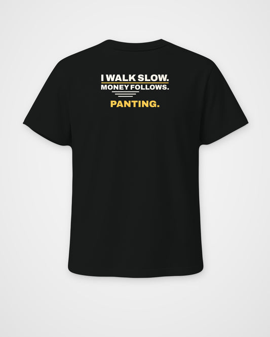 Black regular fit tee, back view, print reading I walk slow. Money follows. Panting – digital mockup