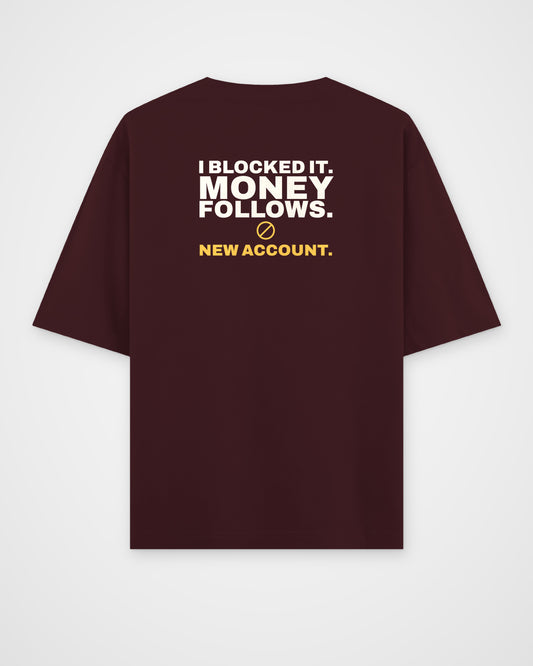 Maroon oversized tee, back view, print reading I blocked it. Money follows. New account – digital mockup