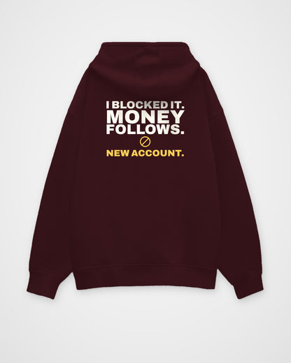 Maroon oversized hoodie, back view, print reading I blocked it. Money follows. New account – digital mockup