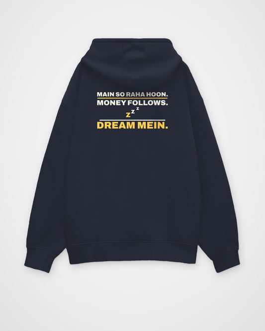 Navy Blue oversized hoodie, back view, print reading Main so raha hoon. Money follows. Dream mein – digital mockup