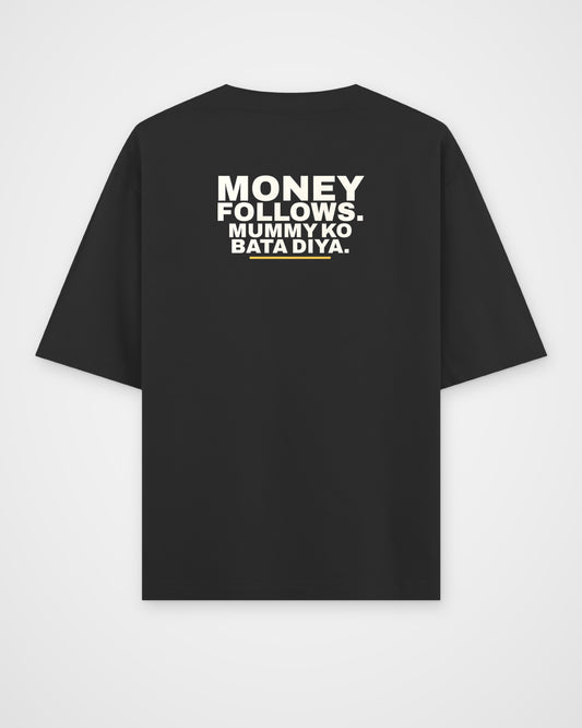 Black oversized tee, back view, print reading Money follows. Mummy ko bata diya – digital mockup