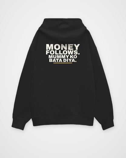 Black oversized hoodie, back view, print reading Money follows. Mummy ko bata diya – digital mockup