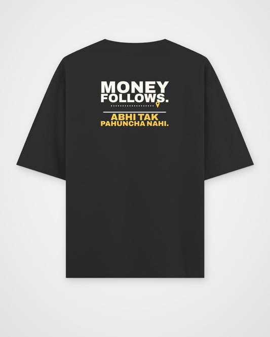 Black oversized tee, back view, print reading Money follows. Abhi tak pahuncha nahi – digital mockup
