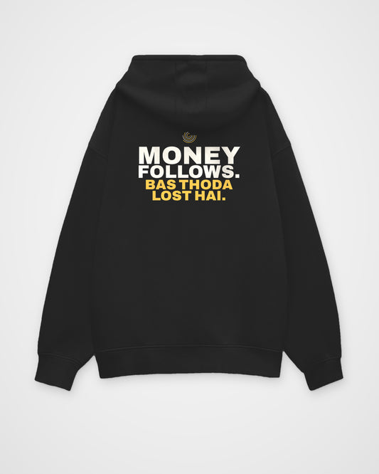 Black oversized hoodie, back view, print reading Money follows. Bas thoda lost hai – digital mockup