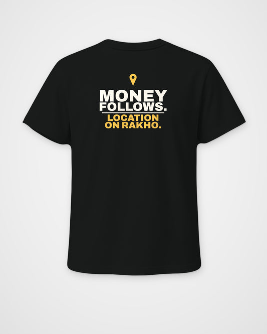 Black regular fit tee, back view, print reading Money follows. Location on rakho – digital mockup
