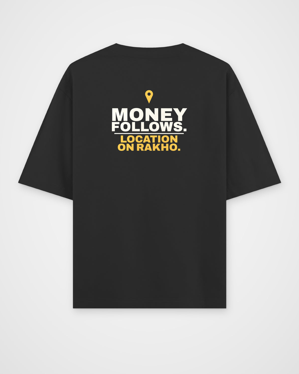 Black oversized tee, back view, print reading Money follows. Location on rakho – digital mockup