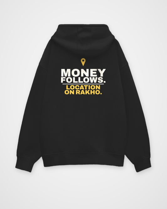 Black oversized hoodie, back view, print reading Money follows. Location on rakho – digital mockup