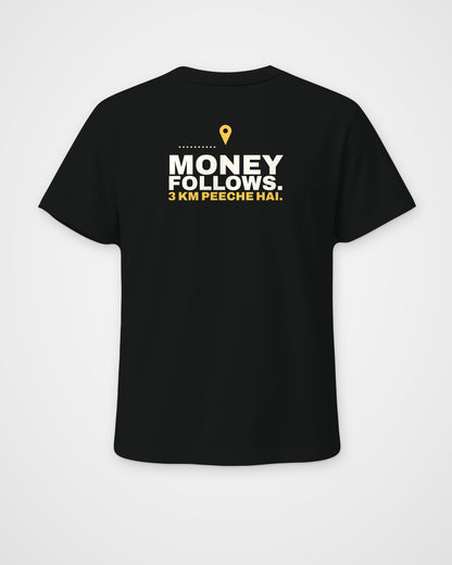 Black regular fit tee, back view, print reading Money follows. 3 km peeche hai – digital mockup