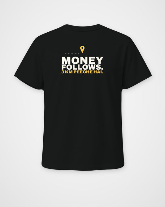 Black regular fit tee, back view, print reading Money follows. 3 km peeche hai – digital mockup