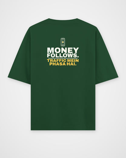 Bottle Green oversized tee, back view, print reading Money follows. Traffic mein phasa hai – digital mockup