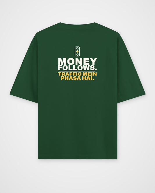 Bottle Green oversized tee, back view, print reading Money follows. Traffic mein phasa hai – digital mockup