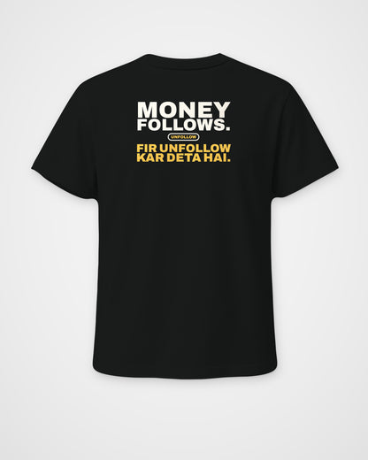 Black regular fit tee, back view, print reading Money follows. Fir unfollow kar deta hai – digital mockup