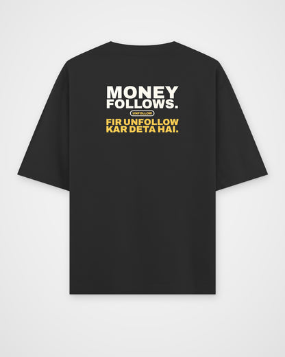 Black oversized tee, back view, print reading Money follows. Fir unfollow kar deta hai – digital mockup