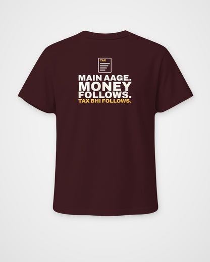 Maroon regular fit tee, back view, print reading Main aage. Money follows. Tax bhi follows – digital mockup
