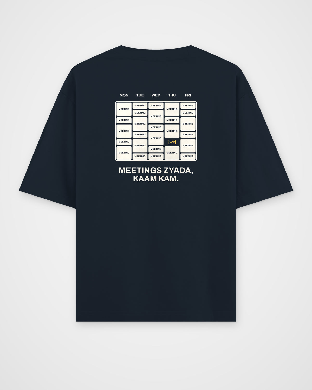 Navy blue oversized t-shirt, back view, with a week calendar full of meetings and Meetings zyada, kaam kam
