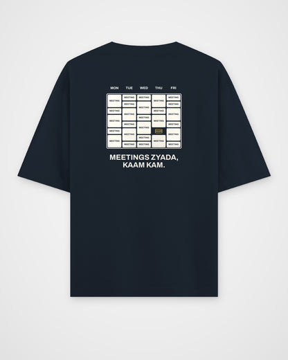 Navy blue oversized t-shirt, back view, with a week calendar full of meetings and Meetings zyada, kaam kam