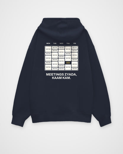 Navy blue oversized hoodie, back view, with a week calendar full of meetings and Meetings zyada, kaam kam