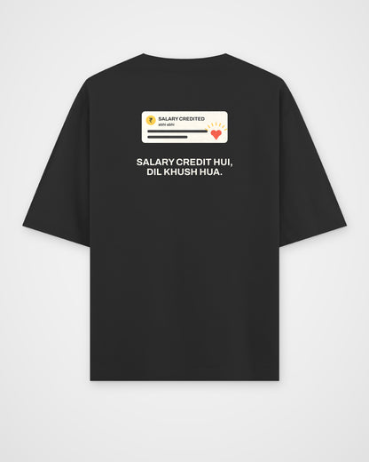 Black oversized t-shirt, back view, with a Salary Credited notification card with a heart and Salary credit – digital mockup