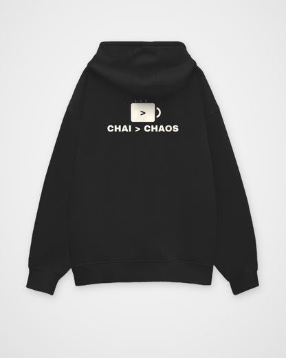 Black oversized hoodie, back view, a minimal chai cup icon and the line CHAI > CHAOS – digital mockup