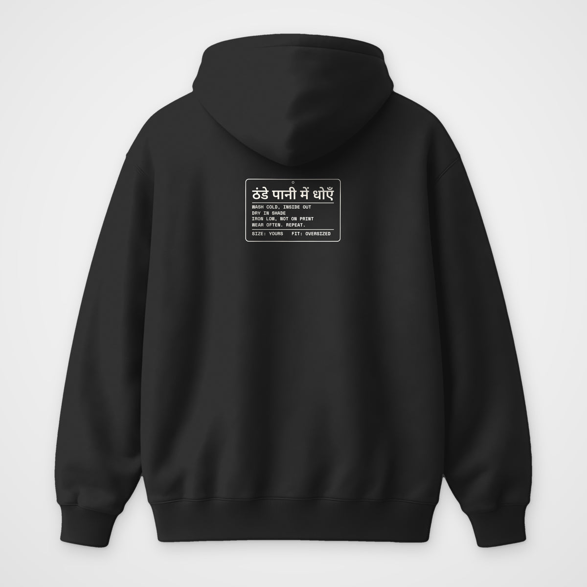 Black oversized hoodie, back view, Care Label print