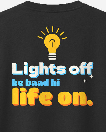 Black oversized t-shirt, close-up of the Lights Off print