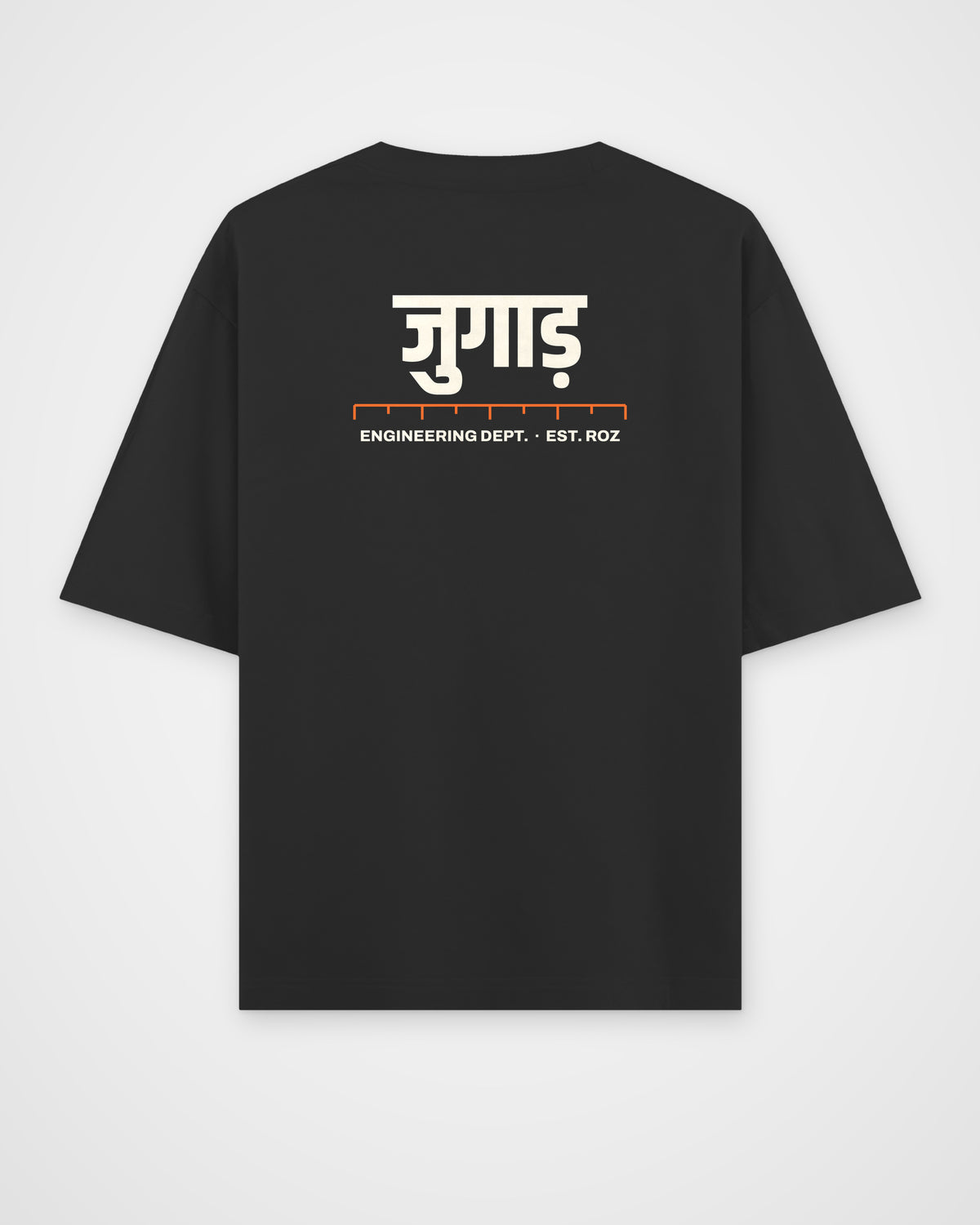 Black oversized t-shirt, back view, a big Hindi wordmark reading jugaad, a ruler and ENGINEERING DEPT. EST – digital mockup