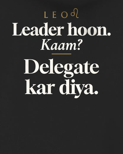Black oversized hoodie, close-up of the back print reading Leader hoon. Kaam? Delegate kar diya.