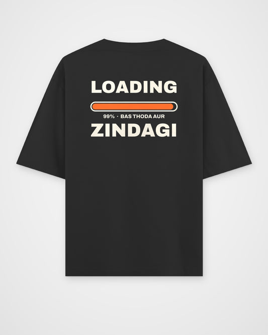 Black oversized t-shirt, back view, huge stacked LOADING 99% type with an orange progress bar stuck at 99% – digital mockup