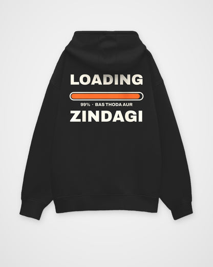 Black oversized hoodie, back view, huge stacked LOADING 99% type with an orange progress bar stuck at 99% – digital mockup