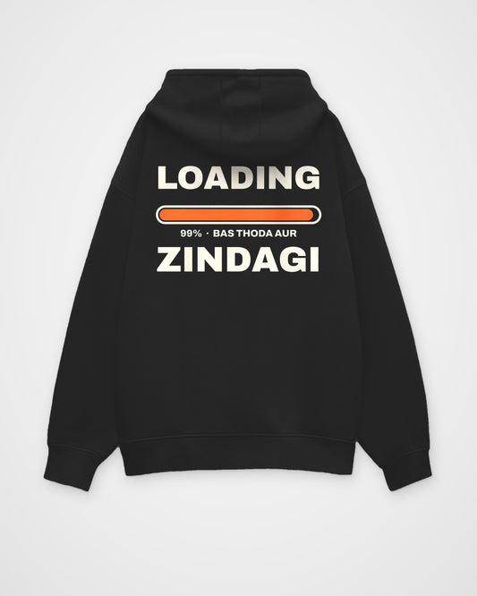 Black oversized hoodie, back view, huge stacked LOADING 99% type with an orange progress bar stuck at 99% – digital mockup