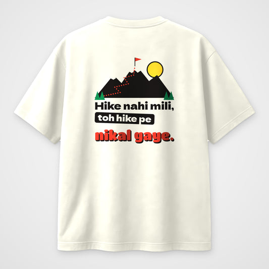 Off white oversized t-shirt, back view, mountain trail print with Hike nahi mili toh hike pe nikal gaye
