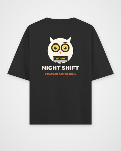 Black oversized t-shirt, back view, a wide-awake owl holding a laptop at 3:47 AM, NIGHT SHIFT and DIMAAG – digital mockup