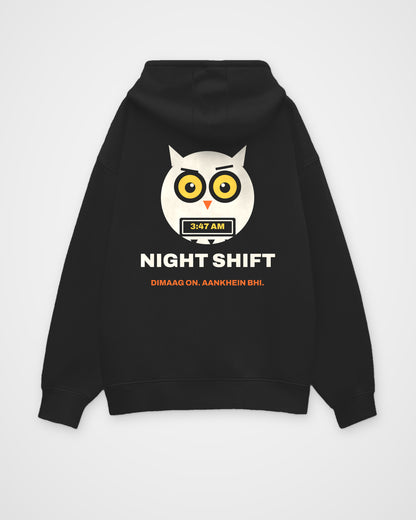 Black oversized hoodie, back view, a wide-awake owl holding a laptop at 3:47 AM, NIGHT SHIFT and DIMAAG ON – digital mockup