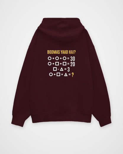 Maroon oversized hoodie, back view with one large puzzle print