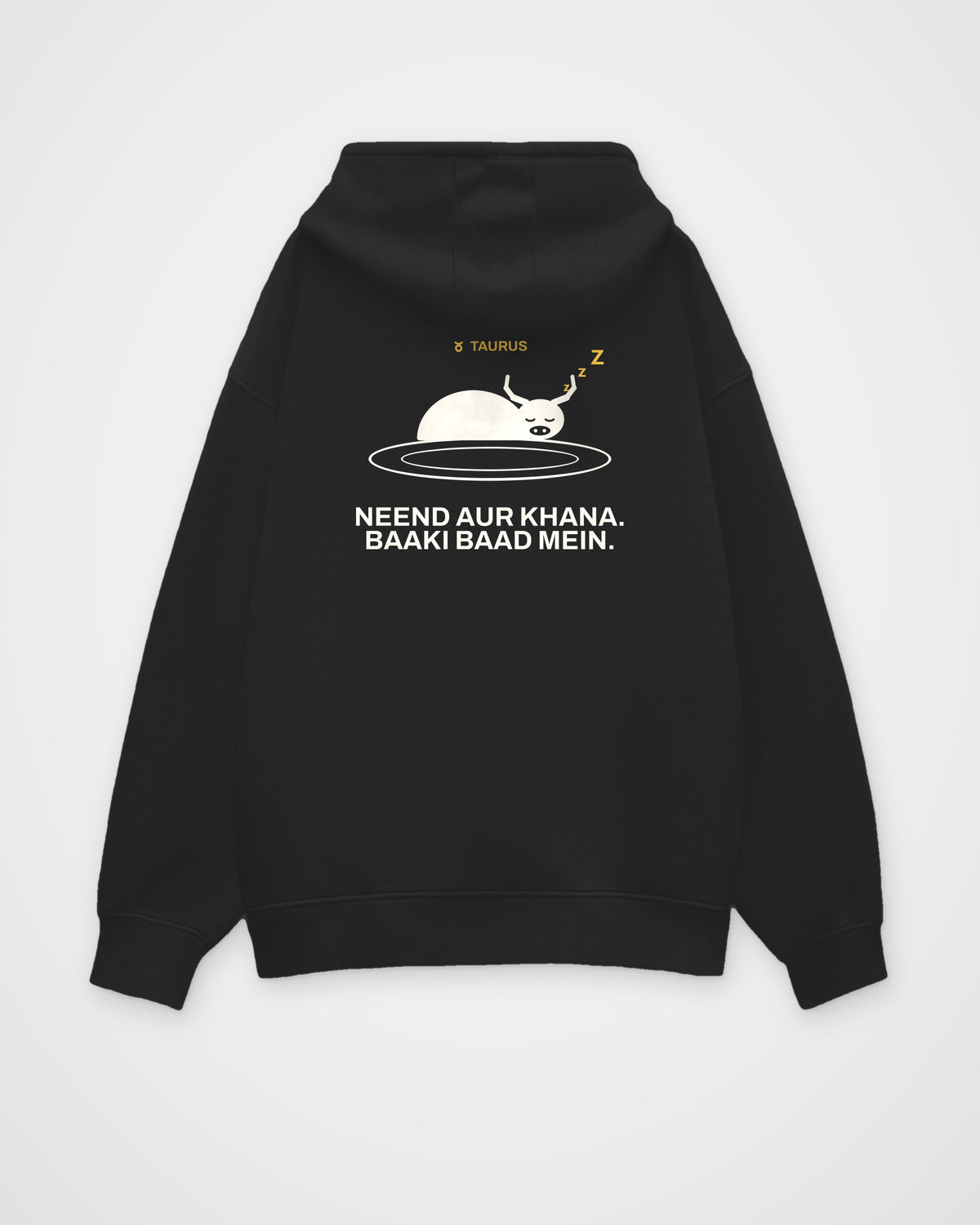 Black oversized hoodie, back view, with a bull asleep on a plate, TAURUS and Neend aur khana. Baaki baad – digital mockup