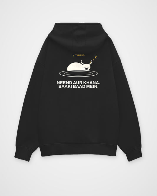 Black oversized hoodie, back view, with a bull asleep on a plate, TAURUS and Neend aur khana. Baaki baad – digital mockup