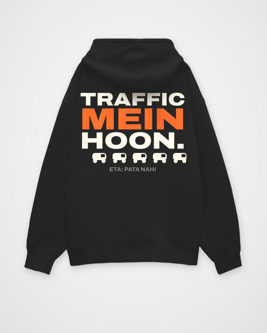 Black oversized hoodie, back view, full-width stacked TRAFFIC MEIN HOON. type, a rickshaw icon row and ETA: – digital mockup
