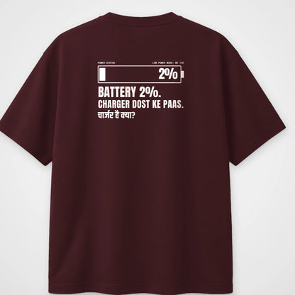 Maroon oversized t-shirt, back view, with a low battery bar and the line Battery 2%, Charger dost ke paas