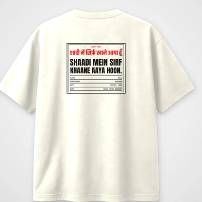 Off white oversized t-shirt, back view, with a wedding guest pass reading Shaadi mein sirf khaane aaya hoon